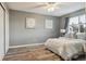 Inviting bedroom featuring wood-look floors, ample natural light, and closet at 6425 Nassau Ct, Highlands Ranch, CO 80130