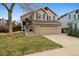 Inviting two-story home featuring a two-car garage, classic architecture, and well-manicured lawn at 6425 Nassau Ct, Highlands Ranch, CO 80130