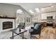 Inviting living area with a fireplace, modern furniture, and an open-concept kitchen at 6425 Nassau Ct, Highlands Ranch, CO 80130