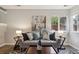Inviting living room with lots of light, stylish decor, a comfortable sofa, and artwork at 6425 Nassau Ct, Highlands Ranch, CO 80130
