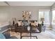 Comfortable living room with stylish decor, large window, and modern furniture at 6425 Nassau Ct, Highlands Ranch, CO 80130