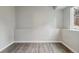 Empty room features wood-look flooring and natural light at 6425 Nassau Ct, Highlands Ranch, CO 80130