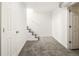 Finished basement with grey carpet and white walls leads to a stairwell at 3755 S Sherman St, Englewood, CO 80113