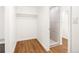 Bathroom with shower stall, wood look flooring and white walls at 3755 S Sherman St, Englewood, CO 80113