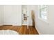Bedroom with hardwood floors, white walls, and view of the home's hall at 3755 S Sherman St, Englewood, CO 80113