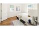 Cozy bedroom with hardwood floors, light walls, large windows, and modern decor at 3755 S Sherman St, Englewood, CO 80113