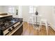 Cozy kitchen featuring stainless steel appliances, a small dining table, and light-filled windows at 3755 S Sherman St, Englewood, CO 80113
