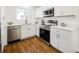 Well-lit kitchen featuring stainless steel appliances, white cabinets, and quartz countertops at 3755 S Sherman St, Englewood, CO 80113