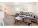 Relaxing living room with a comfortable gray couch and warm, neutral decor and bright orange door at 3755 S Sherman St, Englewood, CO 80113