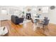Open-concept living room and dining area with fireplace, hardwood floors, and lots of natural light at 3755 S Sherman St, Englewood, CO 80113