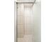 Shower with textured glass door, mosaic tile floors, and vertical wall tile at 3755 S Sherman St, Englewood, CO 80113