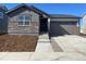 Charming one-story home featuring stone accents, a two-car garage, and a well-manicured front yard at 3911 N Shawnee St, Aurora, CO 80019