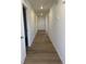 Hallway featuring hardwood floors and access to other rooms in the house at 3911 N Shawnee St, Aurora, CO 80019