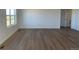 Living room with bright walls, wood floors, and a window at 3911 N Shawnee St, Aurora, CO 80019