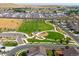 Aerial view showcases a neighborhood park, play area, and extensive green spaces with RV storage in the background at 1181 W 170 Th Ave, Broomfield, CO 80023