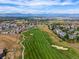 Aerial view of a neighborhood with a golf course, showcasing a community surrounded by lush greenery and scenic views at 1181 W 170 Th Ave, Broomfield, CO 80023