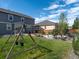 A green backyard featuring a swing set, lawn, and outdoor living spaces at 1181 W 170 Th Ave, Broomfield, CO 80023