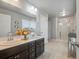 Bathroom featuring double sinks, tile floor and a glass enclosed shower at 1181 W 170 Th Ave, Broomfield, CO 80023