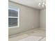 Sunlit bedroom features carpet, a large window, and a modern light fixture at 1181 W 170 Th Ave, Broomfield, CO 80023