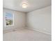 Bright bedroom features neutral carpet, a light fixture, and a window with neighborhood views at 1181 W 170 Th Ave, Broomfield, CO 80023