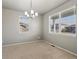 Empty room with neutral carpet and two windows at 1181 W 170 Th Ave, Broomfield, CO 80023