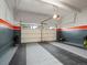 Spacious garage with a gray, white, and orange color scheme, offering ample room for parking and storage at 1181 W 170 Th Ave, Broomfield, CO 80023