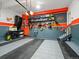 Organized garage featuring a gray and orange color scheme, shelving, and storage for tools and equipment at 1181 W 170 Th Ave, Broomfield, CO 80023