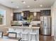 Stylish kitchen featuring stainless steel appliances, a large kitchen island with barstool seating, and pendant lighting at 1181 W 170 Th Ave, Broomfield, CO 80023
