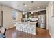 Modern kitchen with stainless steel appliances, granite countertops, kitchen island, and dark wood cabinetry at 1181 W 170 Th Ave, Broomfield, CO 80023
