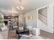 Open-concept living room with hardwood floors, modern furnishings, and staircase in view at 1181 W 170 Th Ave, Broomfield, CO 80023