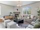 Cozy living room features a fireplace, large windows, hardwood flooring, and comfortable seating at 1181 W 170 Th Ave, Broomfield, CO 80023