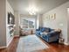Cozy living room with a large window, a blue sofa, and hardwood flooring at 1181 W 170 Th Ave, Broomfield, CO 80023