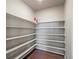 Walk-in pantry with multiple shelves for storage and hardwood flooring at 1181 W 170 Th Ave, Broomfield, CO 80023
