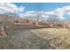 Backyard with retaining wall and mature trees at 16506 E Wesley Ave, Aurora, CO 80013