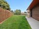 Spacious backyard with a well-maintained lawn and a wooden fence providing privacy at 8233 W 62Nd Pl, Arvada, CO 80004