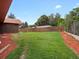 Sprawling backyard featuring a lush lawn, wood fence and mature trees and landscape at 8233 W 62Nd Pl, Arvada, CO 80004