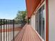 Long, covered balcony with black metal railing and sliding glass doors provides great outdoor living space at 8233 W 62Nd Pl, Arvada, CO 80004