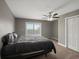 Bedroom featuring a large bed, sliding glass doors, a ceiling fan, and ensuite bathroom access at 8233 W 62Nd Pl, Arvada, CO 80004