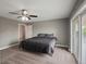 Bright bedroom with large windows, carpeting, and a ceiling fan at 8233 W 62Nd Pl, Arvada, CO 80004