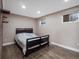 Cozy bedroom with a comfortable bed, light wood floors, and a unique brick accent wall at 8233 W 62Nd Pl, Arvada, CO 80004