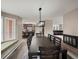 This dining room offers an open concept feel with an abundance of natural light and cozy fireplace at 8233 W 62Nd Pl, Arvada, CO 80004