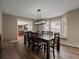 Elegant dining room featuring a modern light fixture, large windows, and a view of the outdoor space at 8233 W 62Nd Pl, Arvada, CO 80004