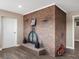Finished basement featuring a cozy brick fireplace with wooden flooring and a decorative motorcycle at 8233 W 62Nd Pl, Arvada, CO 80004