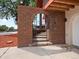 An arched walkway gives access to a gate with steps leading to the front door at 8233 W 62Nd Pl, Arvada, CO 80004