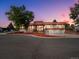 Charming multi-level home with well-maintained yard, three-car garage, and inviting curb appeal at dusk at 8233 W 62Nd Pl, Arvada, CO 80004