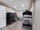 Home gym with wood-look floors, neutral paint, and workout equipment, including treadmill at 8233 W 62Nd Pl, Arvada, CO 80004