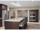 This kitchen features a large island with bar seating, stainless steel appliances, and a built-in oven at 8233 W 62Nd Pl, Arvada, CO 80004