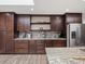This modern kitchen boasts granite countertops, stainless steel appliances, and beautiful wood cabinets at 8233 W 62Nd Pl, Arvada, CO 80004