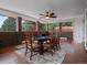 Bright living room with brick walls, tile flooring, large windows, and a ceiling fan at 8233 W 62Nd Pl, Arvada, CO 80004