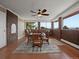 Bright living room with brick walls, tile flooring, large windows, and a ceiling fan at 8233 W 62Nd Pl, Arvada, CO 80004